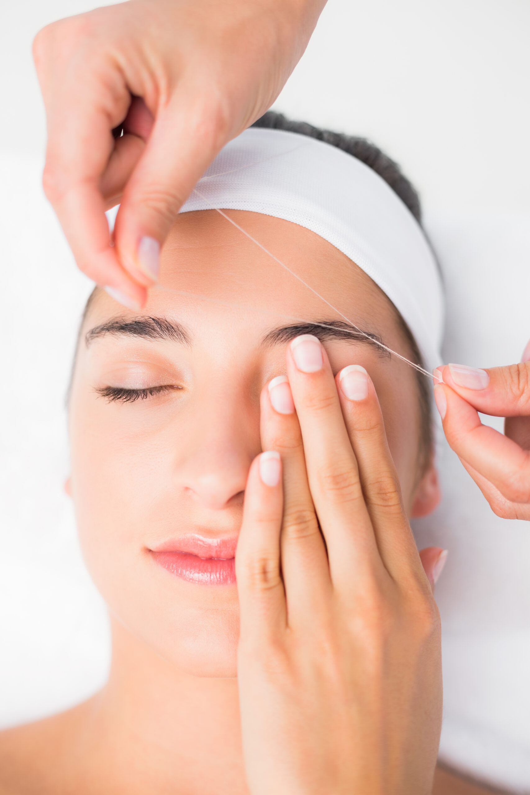 hands threading beautiful womans upper eyes scaled